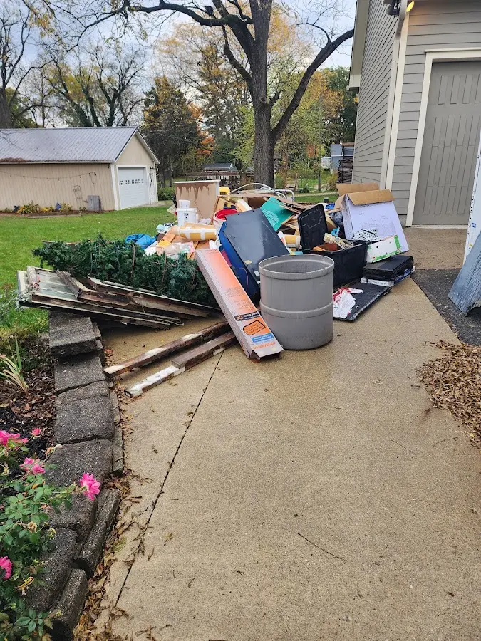 Dumpster being loaded with debris for Estate Cleanout Dumpster Rental in Burlington